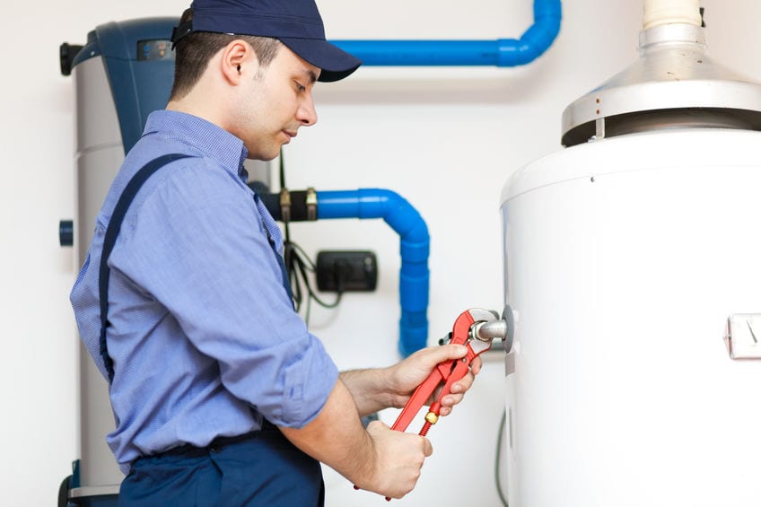 plumber performing water heater maintenance in manassas va